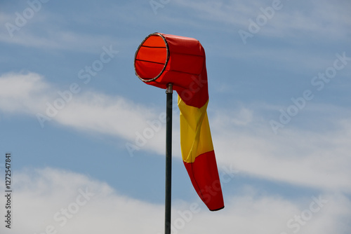 White and red striped wind sock. Strong wind and bad weather symbol. Climate Change. Weather forecast. Storm is coming. photo