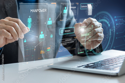 Businessman interacting with futuristic manpower control panel for human resource  management and employment strategy planning