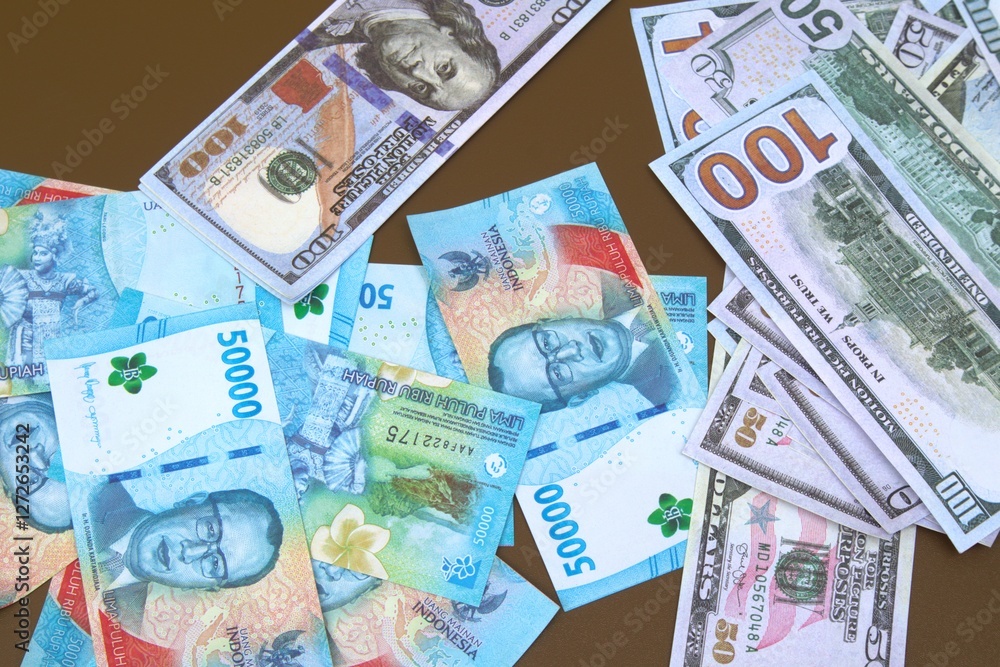 stacks of 100 dollar bills and 50,000 rupiah on a brown table stacks of 100 dollar bills and 50,000 rupiah on a brown table