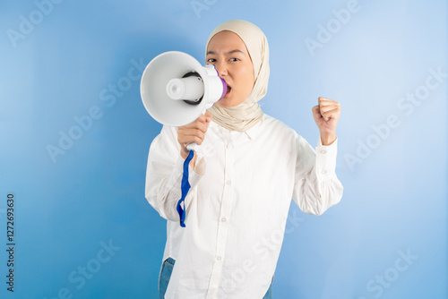 portrait of female holding megaphone shouted while clenching his fist