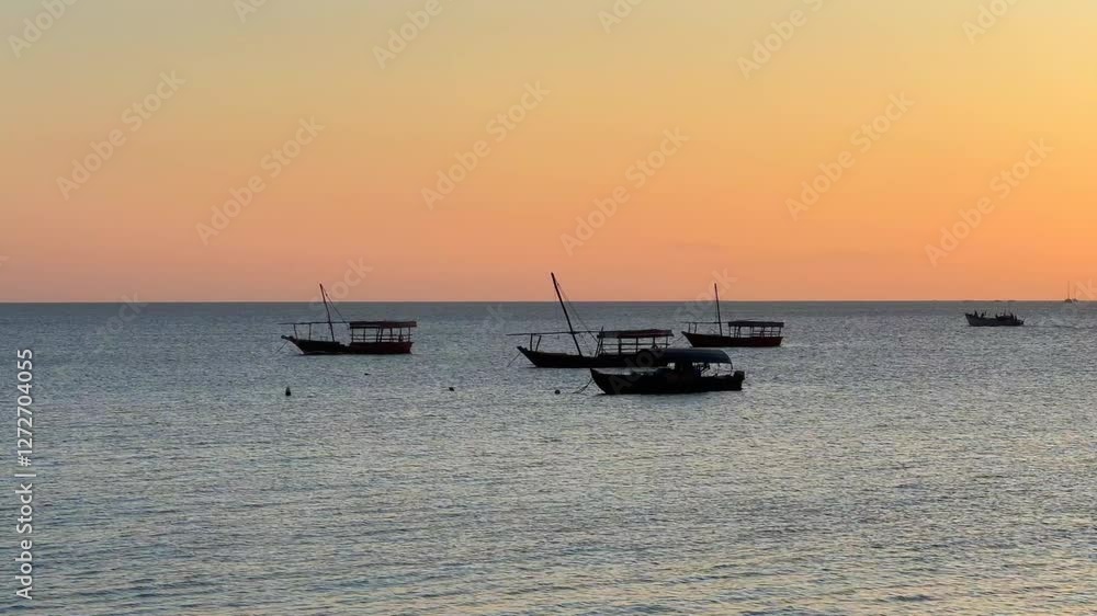 Traditional boats on the coast of Stone Town after sunset. Zanzibar, Tanzania. Traditional boats on the coast of Stone Town after sunset. Zanzibar, Tanzania.