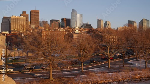 Boston city skyline and evening traffic seen from Longfellow bridge over Charles river during winter sunset photo