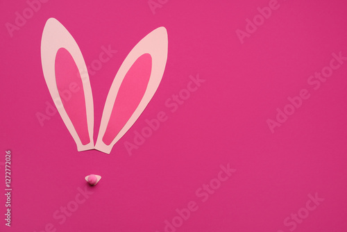 Paper bunny ears on pink background