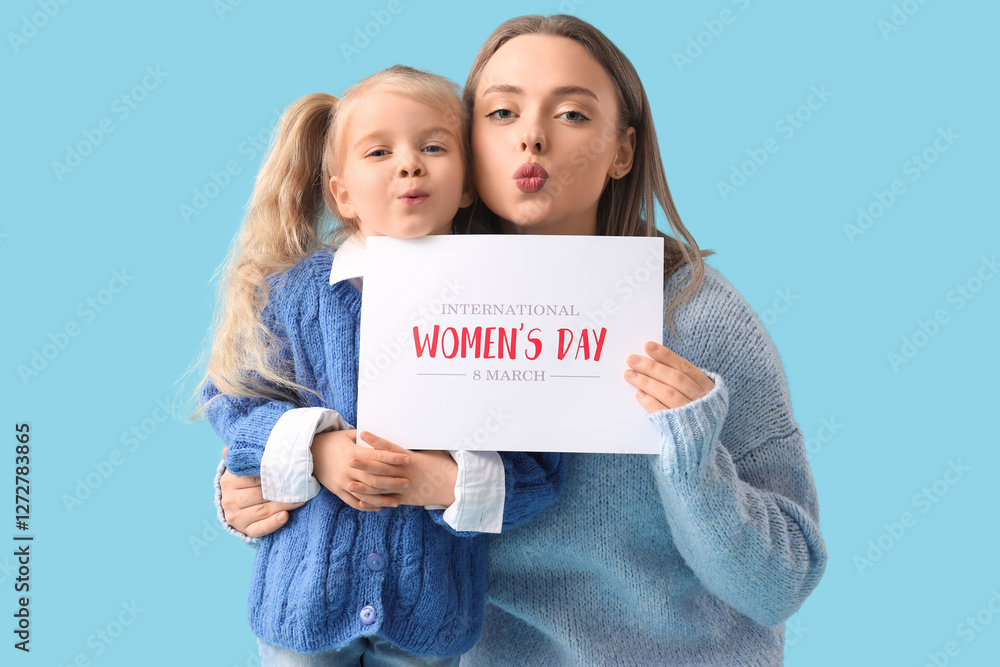 Little girl with her mother and festive postcard on blue background. International Women's Day Little girl with her mother and festive postcard on blue background. International Women's Day