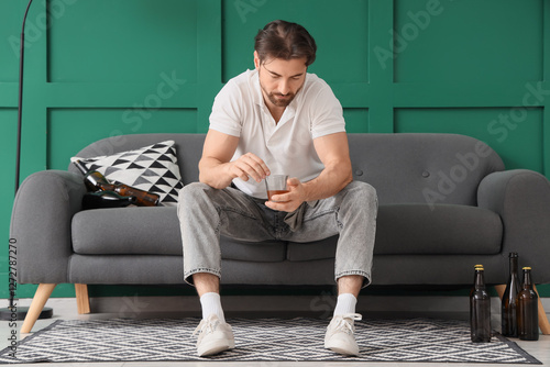 Drunk man with whiskey sitt...