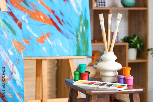 Stool with art supplies nea...