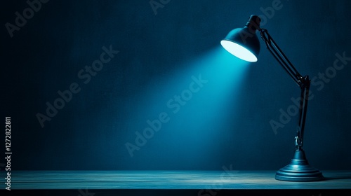 Illuminated desk lamp casting blue light on dark wood surface.