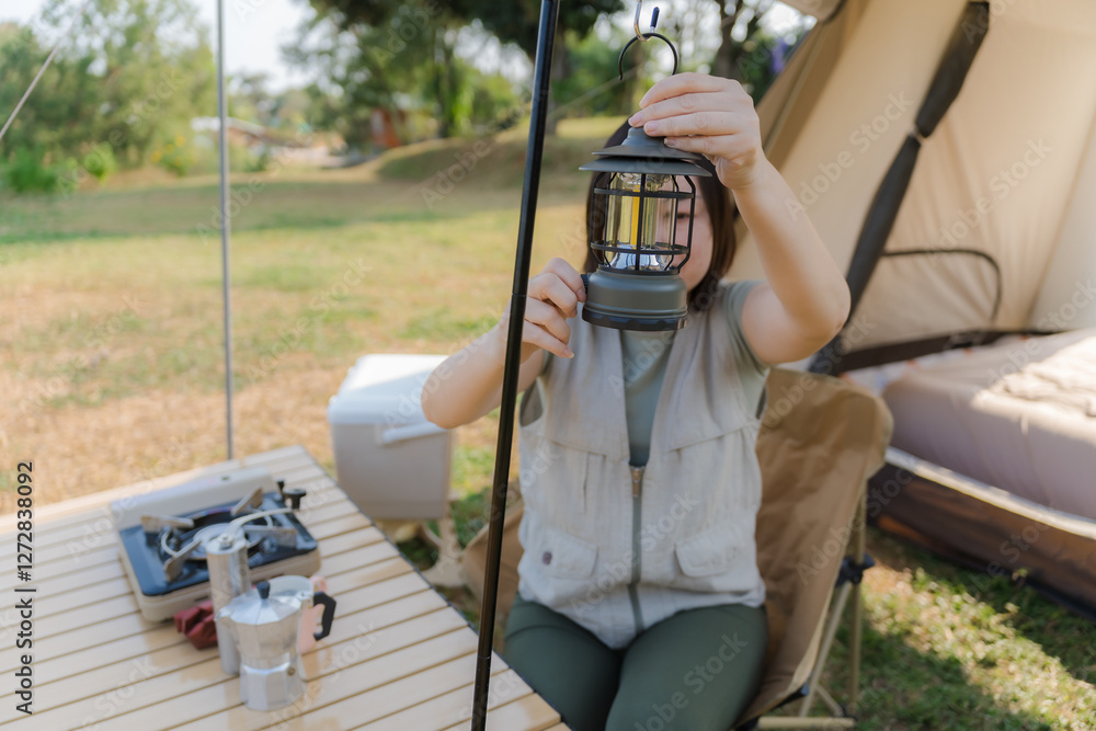 Asian woman enjoys camping during her vacation. Asian woman enjoys camping during her vacation.