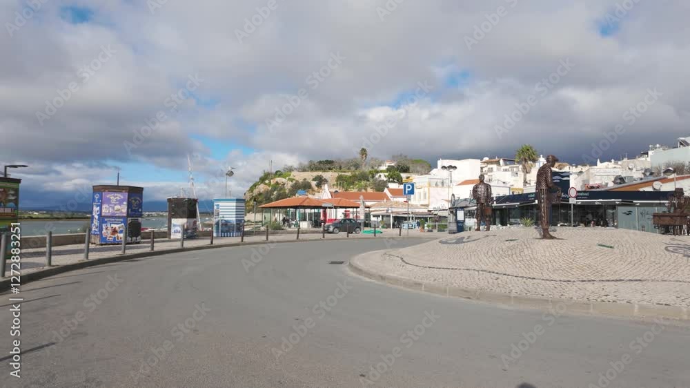 Roundabout with statues representing fishermen, located in the charming fishing village of Alvor, in the Algarve region, southern Portugal Roundabout with statues representing fishermen, located in the charming fishing village of Alvor, in the Algarve region, southern Portugal