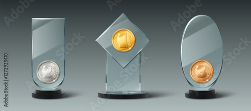 Glass trophy collection decorated with ranking medals - gold first place, silver second, bronze third with laurel sign. Transparent 3d award stands in different geometric shapes on dark bases.