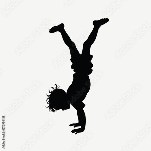 Child doing a handstand against a light background