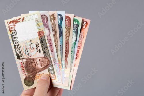 Colombian money - Pesos in the hand on a gray background photo