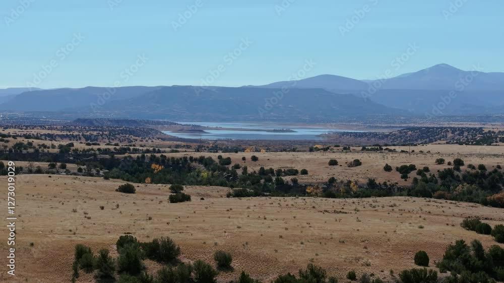 Scenic aerial view of Abiquiu Lake, New Mexico with surrounding hills and dry landscape Scenic aerial view of Abiquiu Lake, New Mexico with surrounding hills and dry landscape