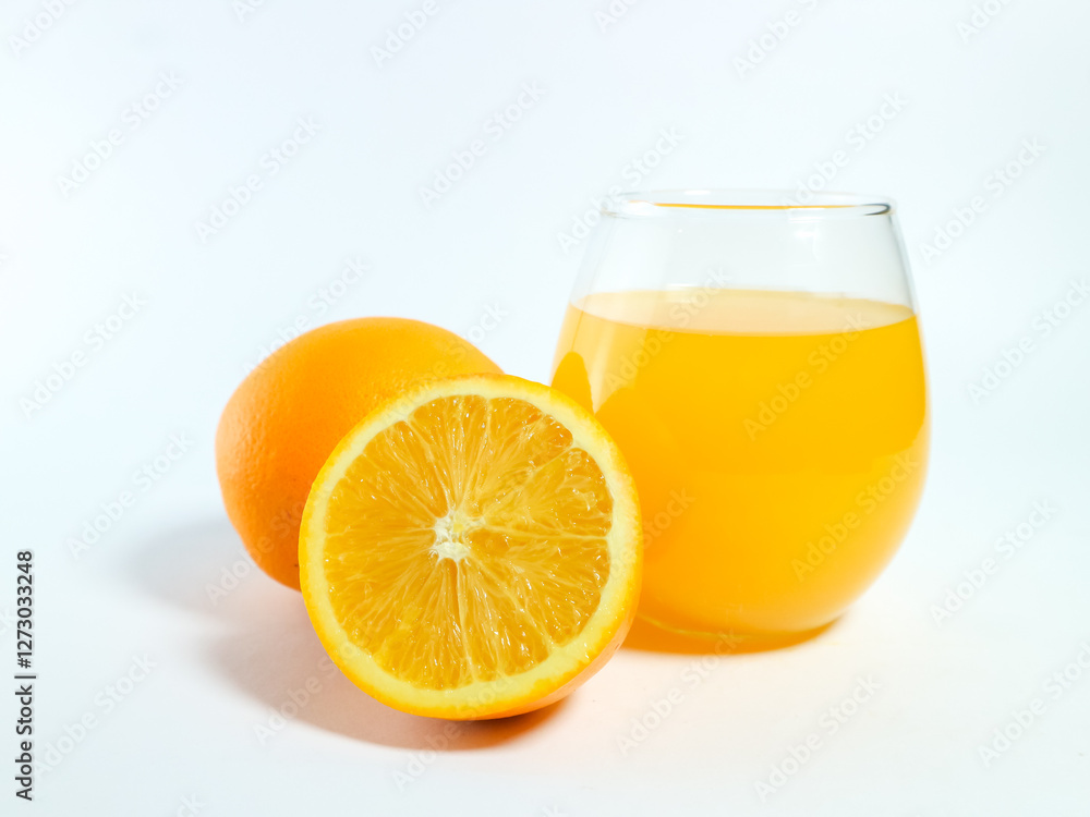 Fresh orange juice in a glass with whole and sliced oranges isolated on a white background Fresh orange juice in a glass with whole and sliced oranges isolated on a white background