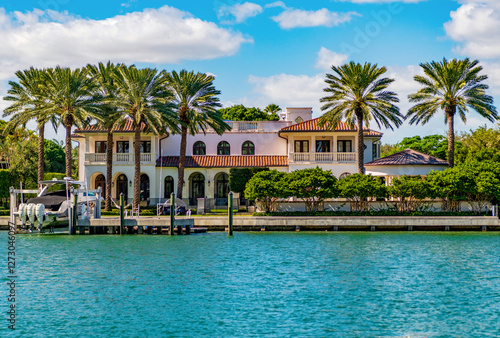 Waterfront landscape with house. Vacation in summer. Luxury waterfront hotel building. Summer vacation. Landscape with luxury residential area. Residential waterfront apartment. Palm tree photo