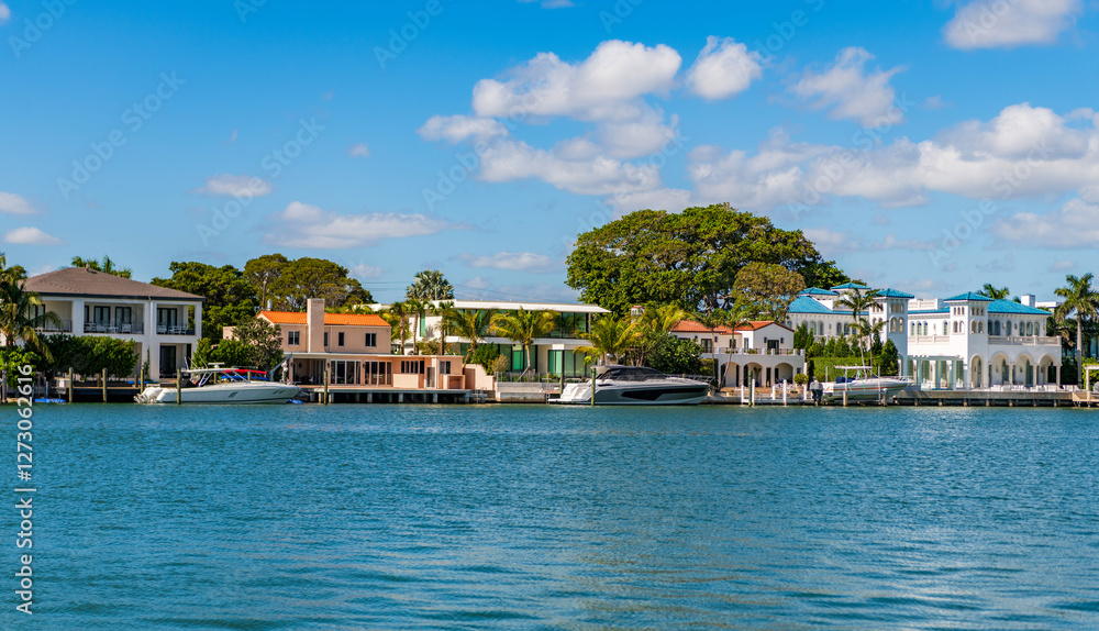 Obraz premium Vacation in summer. Luxury waterfront hotel building. Summer vacation. Yacht in luxury residential. Residential waterfront apartment with boat. Waterfront landscape with house. Travel destination