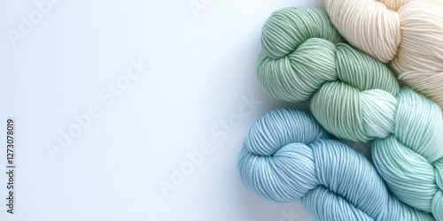 Soft pastel yarn skeins on a white background for knitting and crochet projects photo