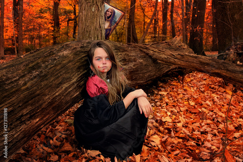 Teen girls dressed up for Halloween in colorful woods