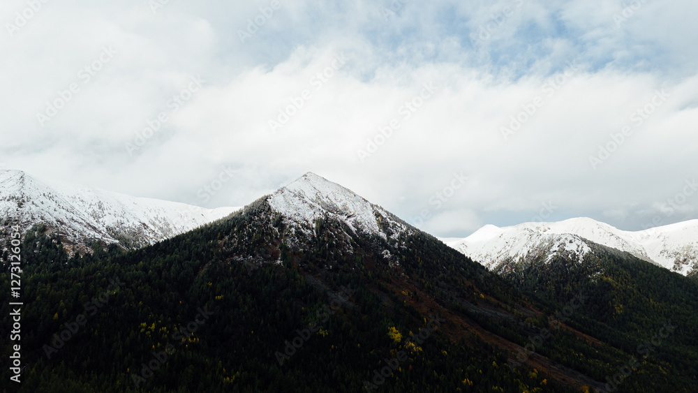 Fototapeta premium Snow-capped mountains of Oka District, showcasing the pristine and majestic beauty of the winter landscape from an aerial drone perspective