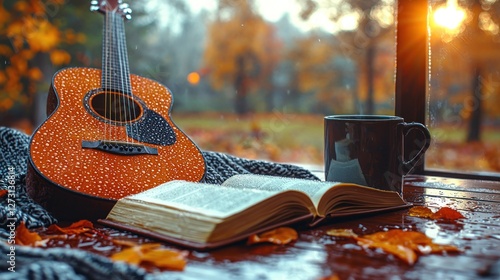 Cozy autumn scene featuring a guitar, book, and coffee cup by a window