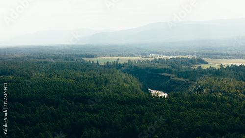 A river winding through mountains in Zakamensky District, Buryatia. Majestic peaks and serene natural beauty. photo