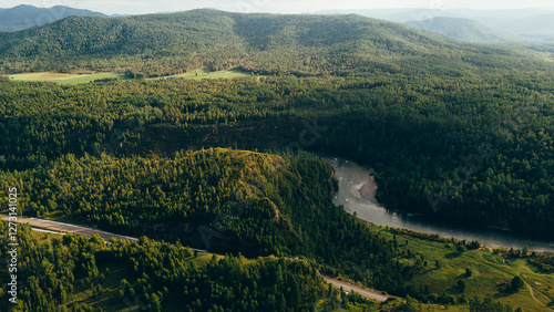 A river winding through mountains in Zakamensky District, Buryatia. Majestic peaks and serene natural beauty. photo