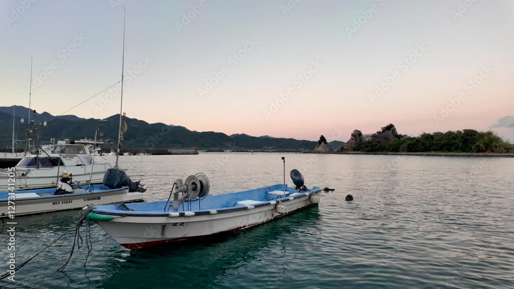 Boats gently floating in Nachi Bay with Benten Island in the background, capturing the serene atmosphere of the golden hour Boats gently floating in Nachi Bay with Benten Island in the background, capturing the serene atmosphere of the golden hour