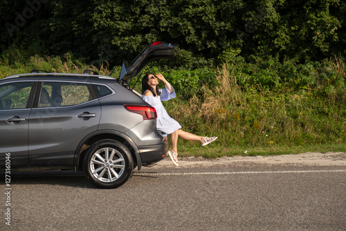 Woman Relaxing on SUV in Nature