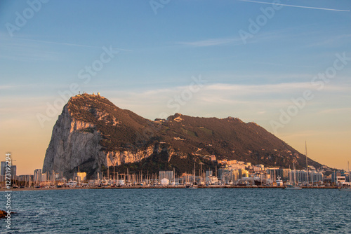 Sunrise over the Rock of Gibraltar with calm waters and coastal skyline in the early morning light