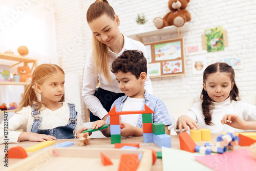 Kids playing with wooden cubes.