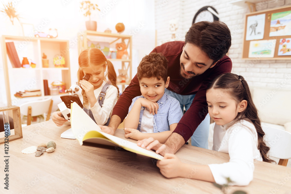 The children together are reading the book together. The children together are reading the book together.