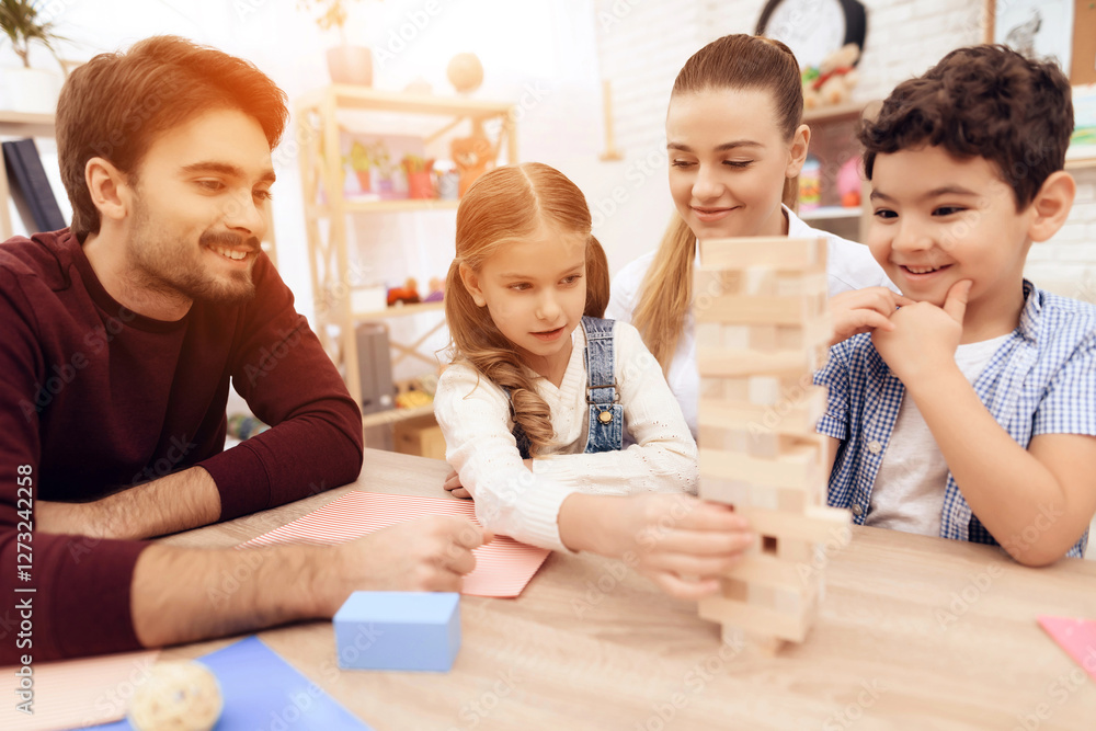 Children play Jenga with adults. Children play Jenga with adults.