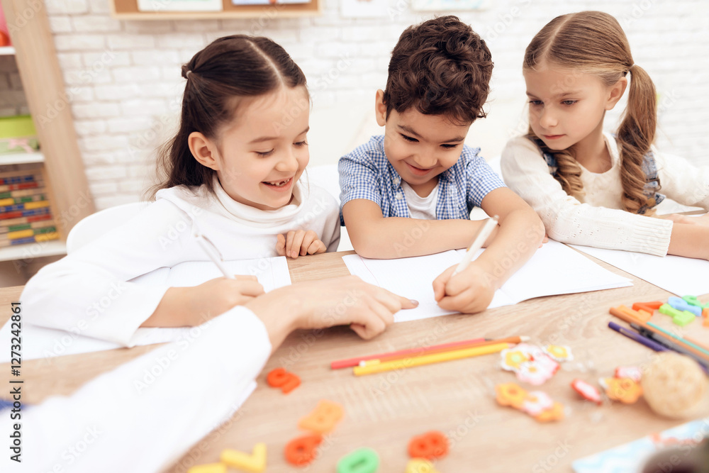 Children write in notebooks with a pen. Children write in notebooks with a pen.