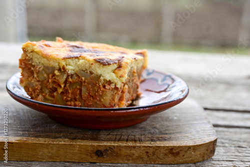  Potato and minced meat  Casserole  with   parmesan cheese and garlic on wooden rustic bakcground.  Bulgarian moussaka photo