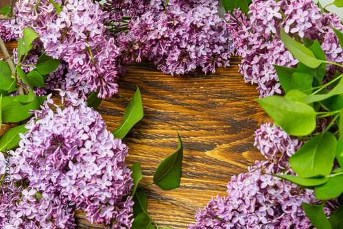 Beautiful spring flowers lilac on a wooden vintage board with place for text. Syringa vulgaris. Happy Mother's Day greetings card.