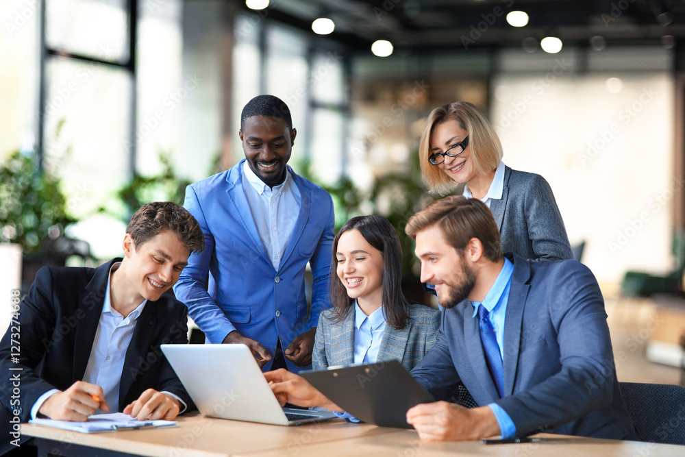 Group of young modern people in suits using modern technologies while working in the creative office. Group of young modern people in suits using modern technologies while working in the creative office.