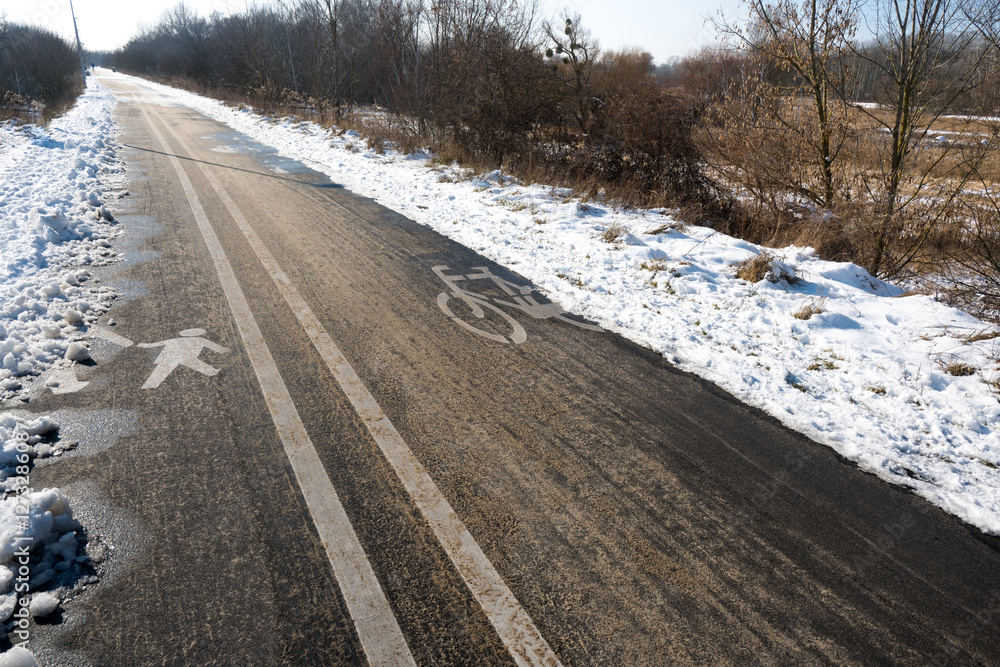 Road markings with separate lanes for pedestrians and bicycles. Winter conditions.