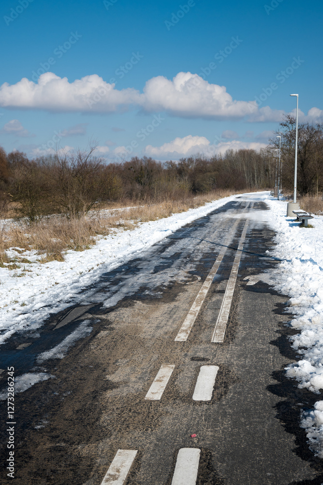 Road markings with separate lanes for pedestrians and bicycles. Winter conditions.