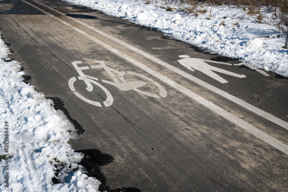 Road markings with separate lanes for pedestrians and bicycles. Winter conditions.