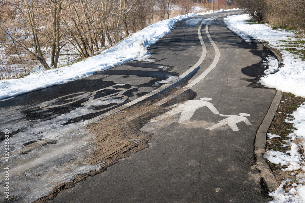 Road markings with separate lanes for pedestrians and bicycles. Winter conditions.