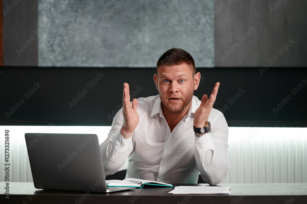 Businessman working on a laptop with a coffee. Businessman in a white shirt sits at the table with a surprised face with his hands spread out. Businessman working on a laptop with a coffee. Businessman in a white shirt sits at the table with a surprised face with his hands spread out.