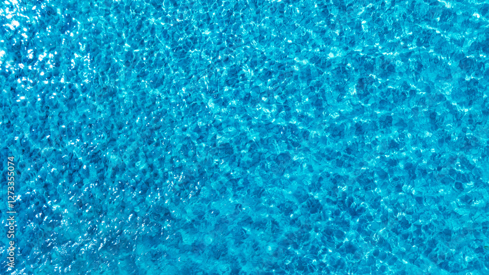 Top view beach sand background for summer vacation concept. Beach nature and summer seawater with sunlight light sandy beach Sparkling sea water Top view beach sand background for summer vacation concept. Beach nature and summer seawater with sunlight light sandy beach Sparkling sea water