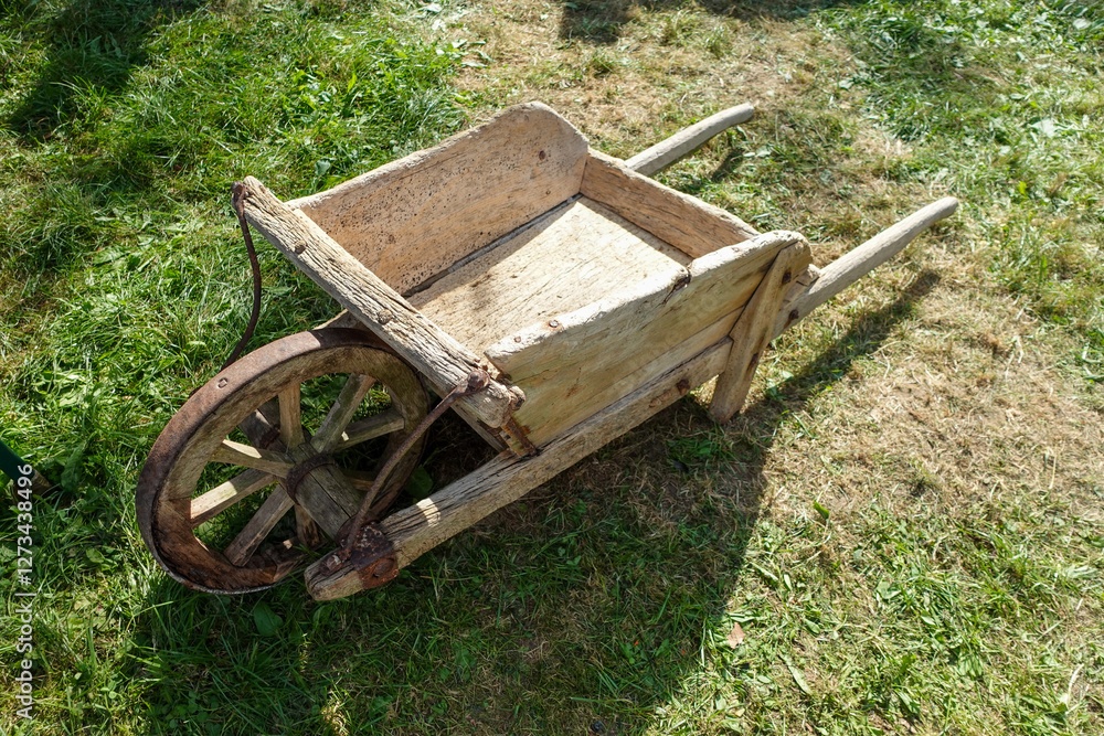 Antique Wooden Wheelbarrow on Grass Antique Wooden Wheelbarrow on Grass