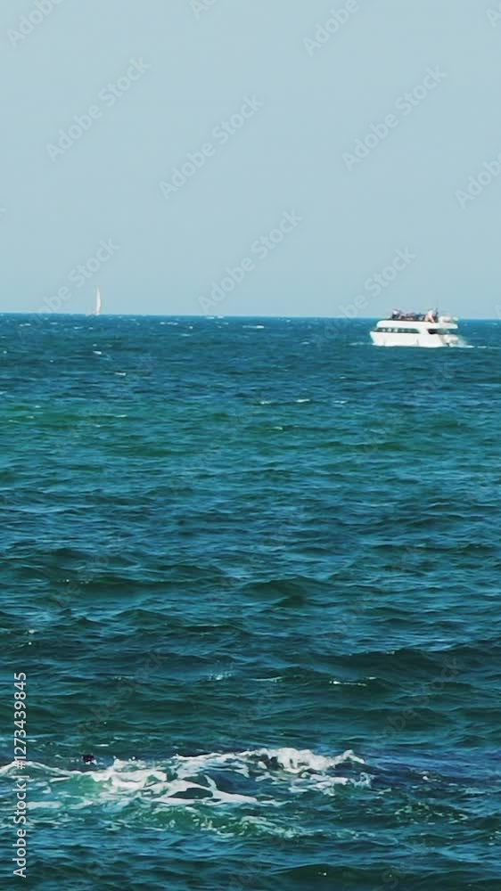 Luxury private motor yacht in the sea. Yacht sailing on open sea at sunny day. Sea resort Vertical video Luxury private motor yacht in the sea. Yacht sailing on open sea at sunny day. Sea resort Vertical video