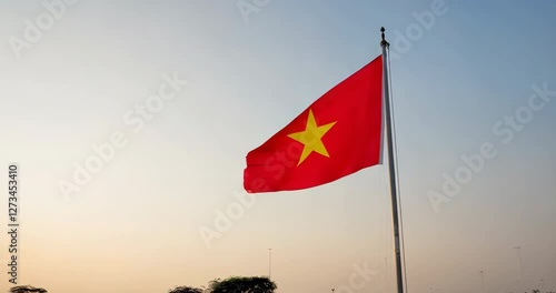 The Vietnamese flag waves in the wind at dusk