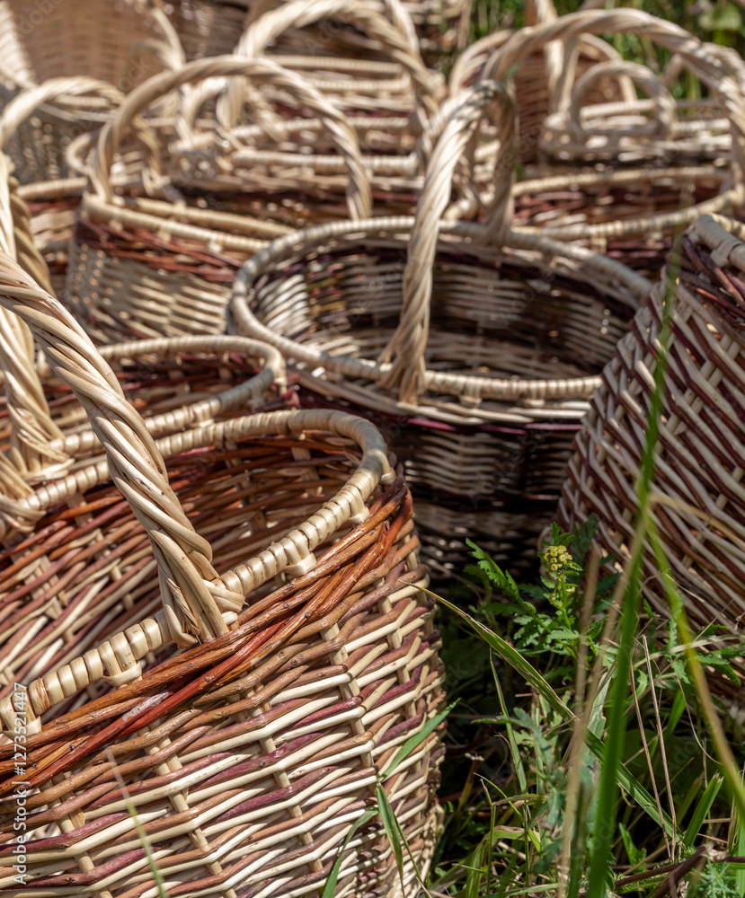 Bunch of baskets made of wicker are sitting in a field Bunch of baskets made of wicker are sitting in a field