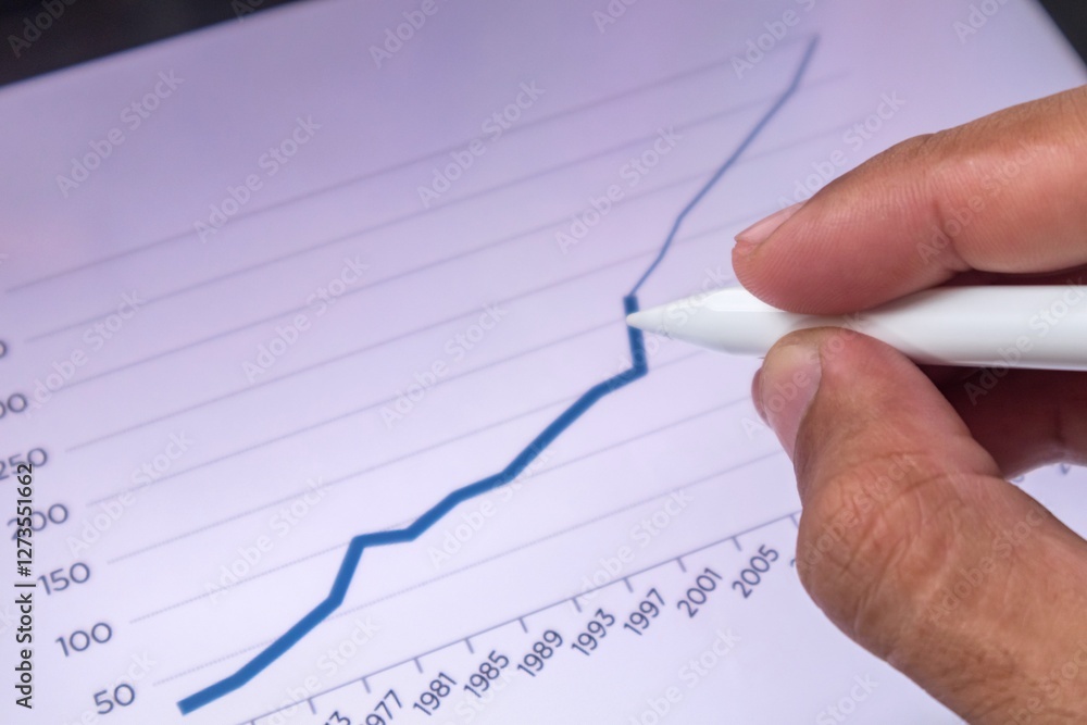 Businessman analyzing business financial data and market growth graphic report on digital screen Businessman analyzing business financial data and market growth graphic report on digital screen