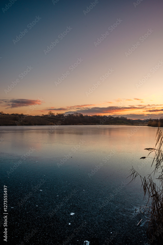 Beautiful blue hour on the lake, trees on the beach , sunrise over the lake with blue sky without clouds.Landscape photography on the pond , purple colors on the sky , trees and water , reflections Beautiful blue hour on the lake, trees on the beach , sunrise over the lake with blue sky without clouds.Landscape photography on the pond , purple colors on the sky , trees and water , reflections