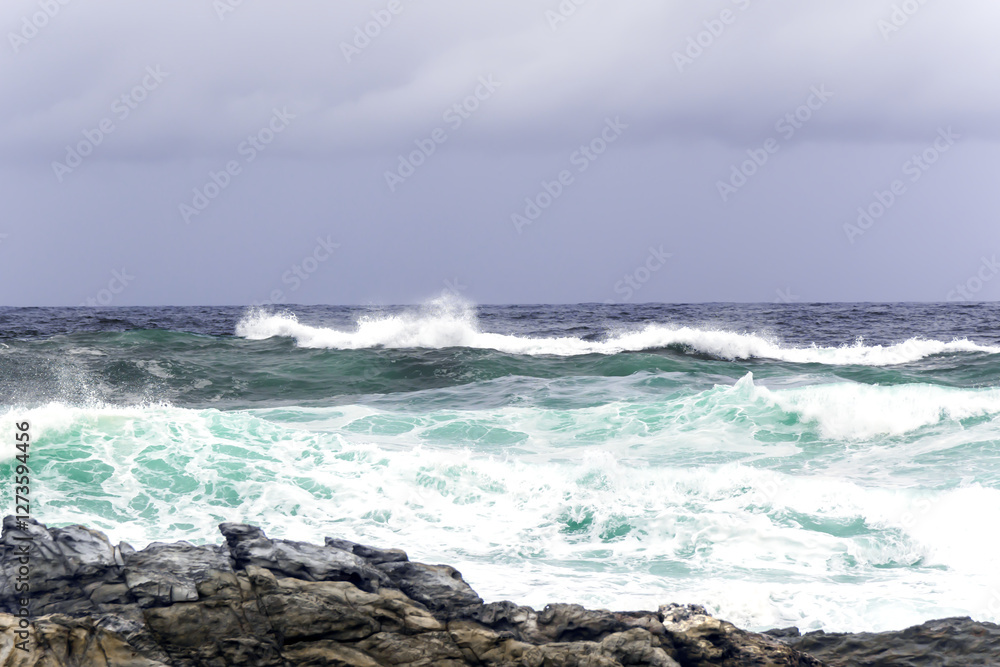 Fototapeta premium Large Indian Ocean waves and rocky coastline in Tsitsikamma, Garden Route National Park, Eastern Cape. South Africa 