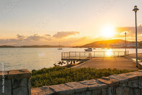 Small fishing jetty illuminated by late afternoon sunshine at Lake Macquarie photo